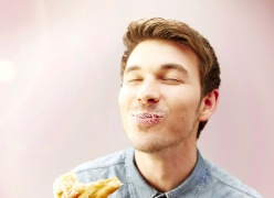 A man eating a doughnut.