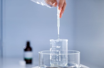 Liquid flavour dripping into glass from a pipette