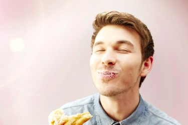 A man eating a doughnut.