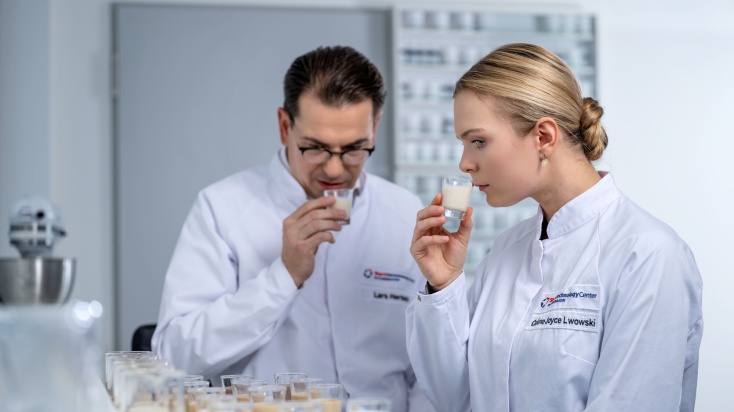two flavour experts test smelling flavour samples in application lab
