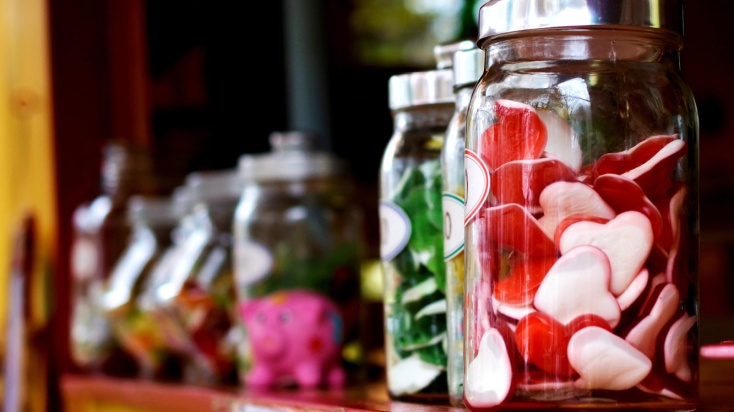 Row of candy jars on shelf