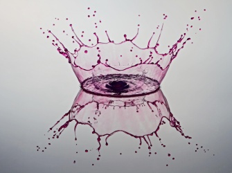 A purple splash of liquid. The splash looks like a crown.