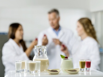 Three technologist tasting food