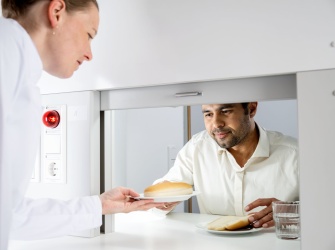 Test tasting situation: a technologist hads a panelist samples for tasting.